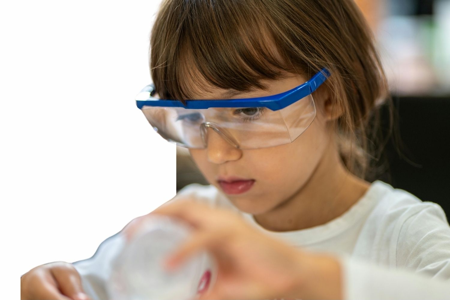 A young learner exploring science with safety goggles